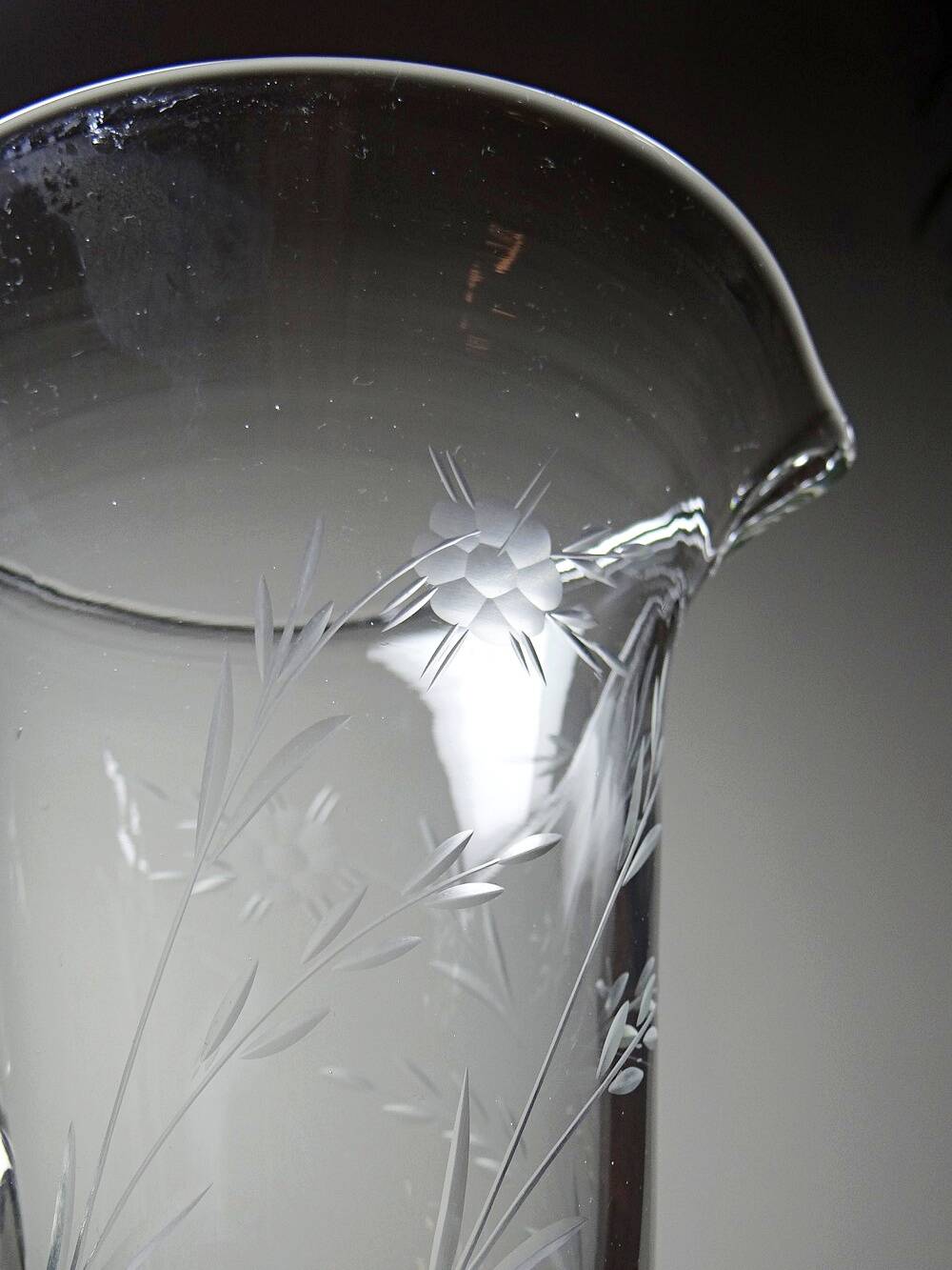 Antique glass pitcher with wheel engraving and floral decoration, Bohemia, early 20th century.