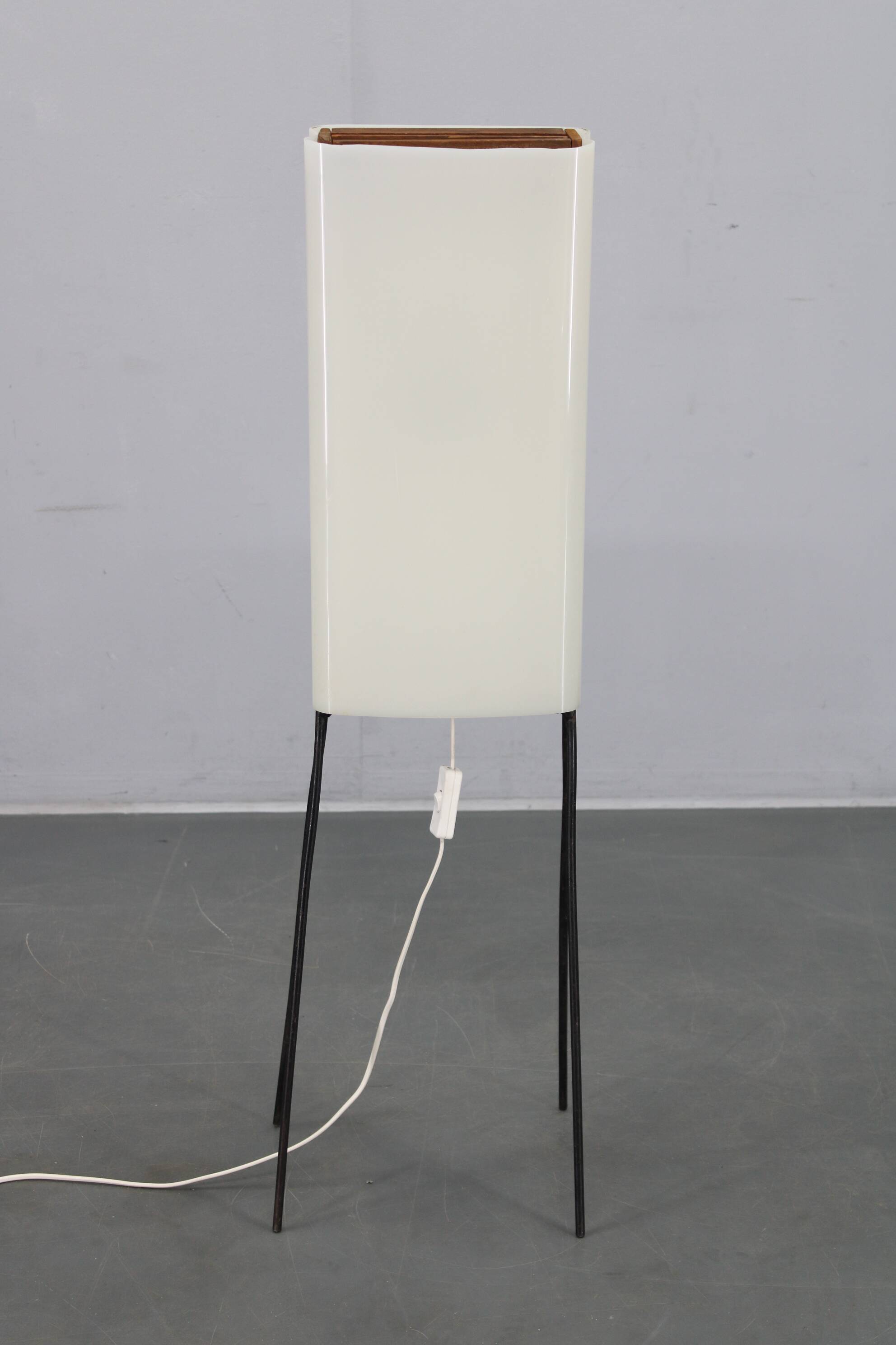 Mid-century modern floor lamp on iron legs with plastic shade and wood accent