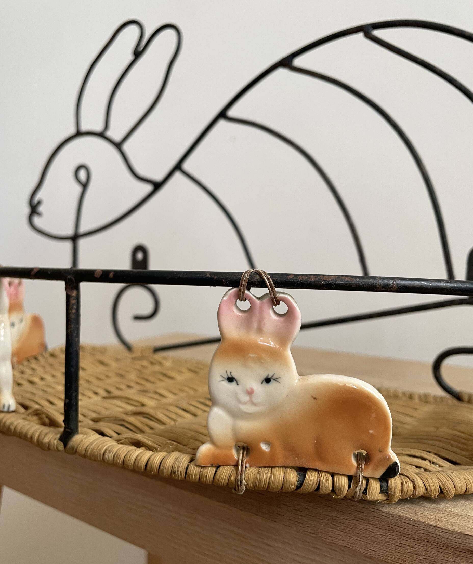 Wrought iron shelf and porcelain rabbit figurines