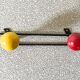 Vintage wall coat rack, metal and wood in yellow and red.