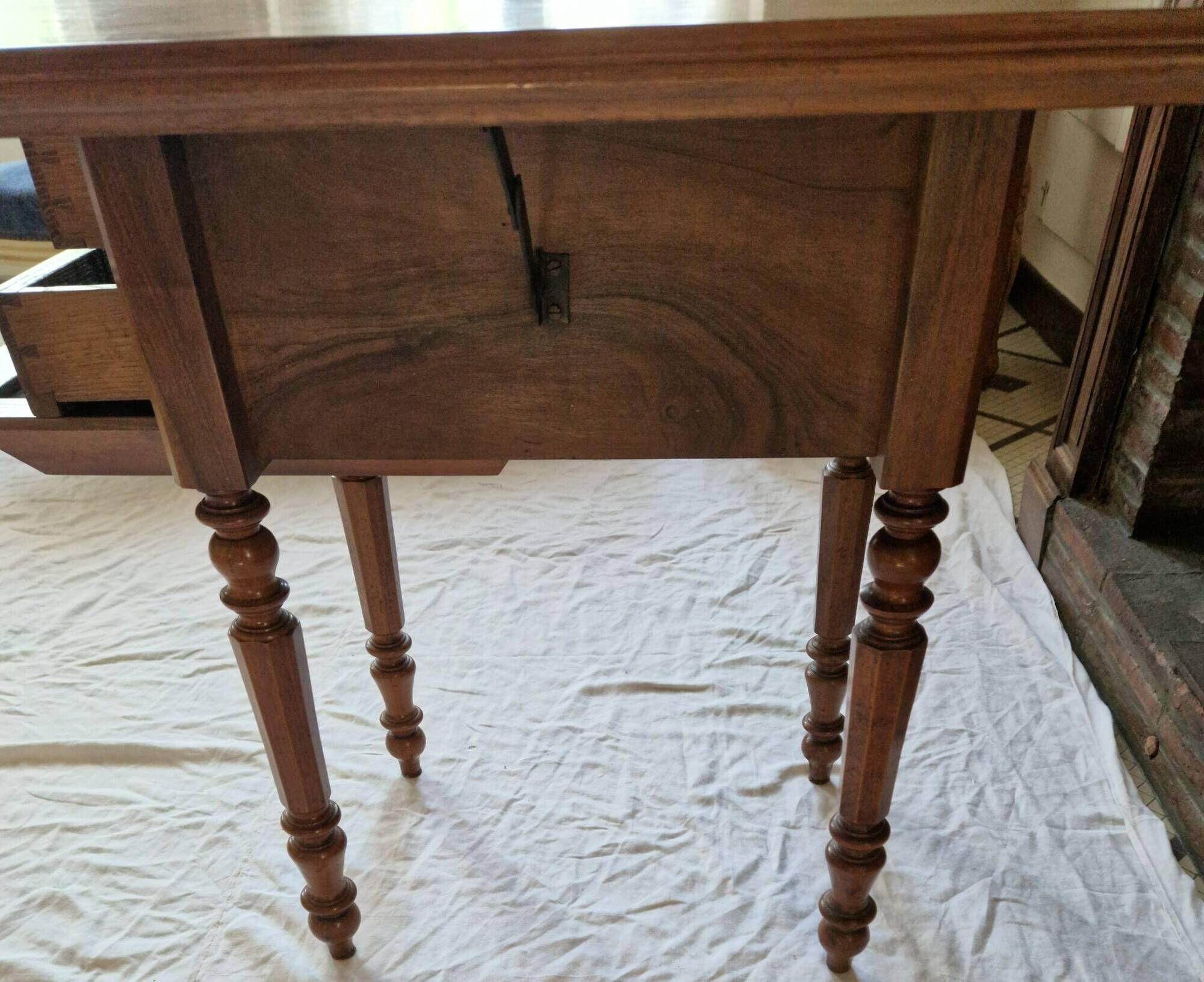 Nineteenth-century walnut work table with flaps, large storage + secret drawer.