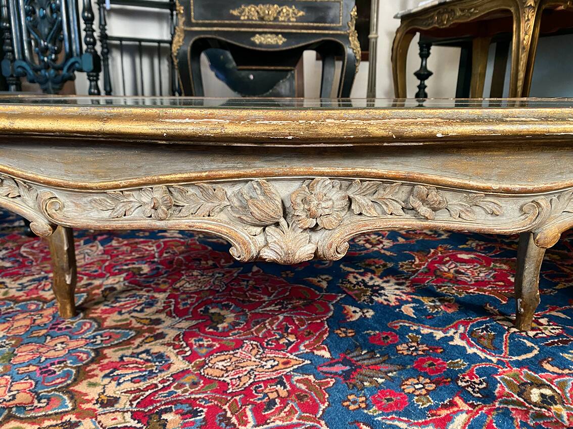 Louis XV style coffee table in carved wood with grey and gold highlights.