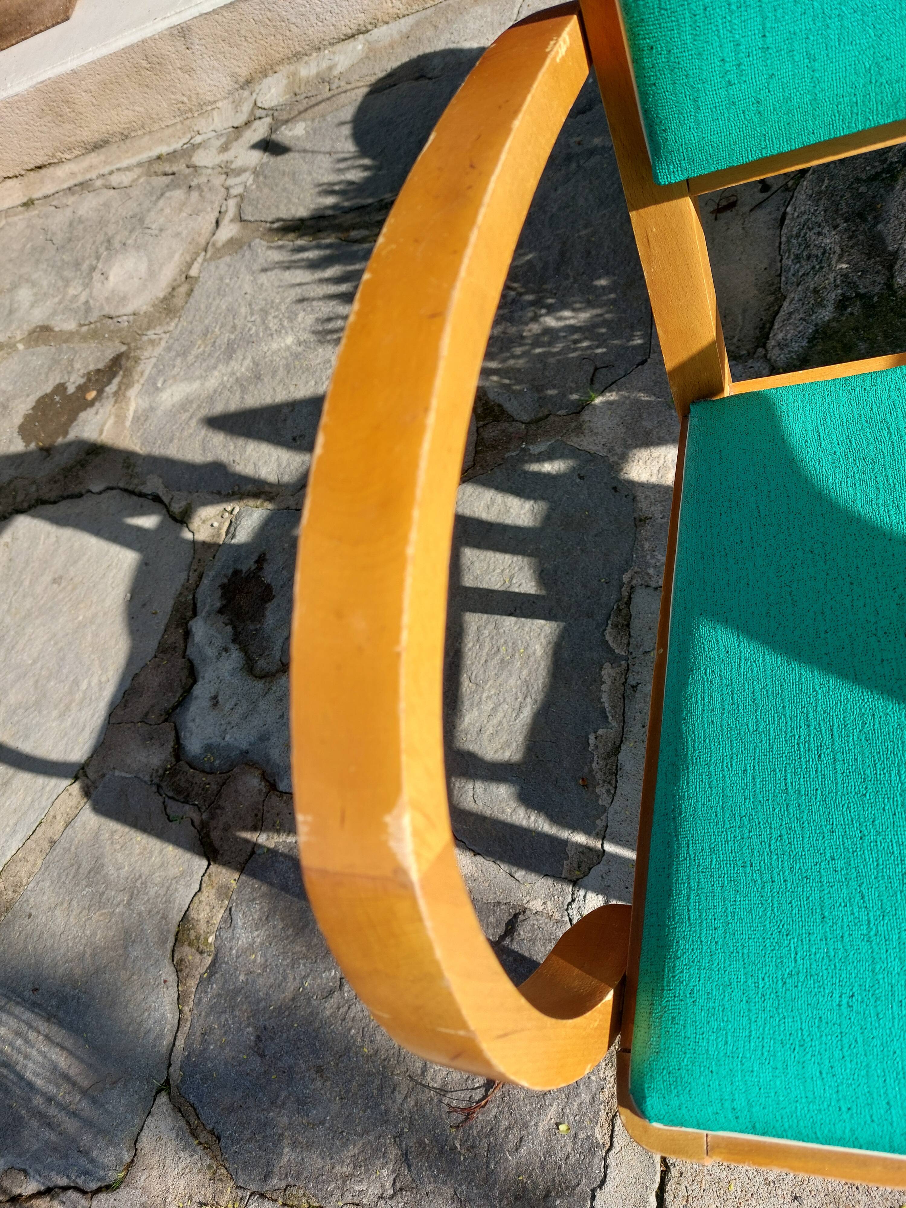 3 vintage bridge chairs with rounded armrests.