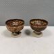 A set of ceramic candle holders in earthy colours.