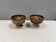 A set of ceramic candle holders in earthy colours.