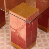 Modern coffee table in burgundy zellige with a tempered glass top.