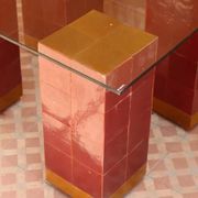 Modern coffee table in burgundy zellige with a tempered glass top.