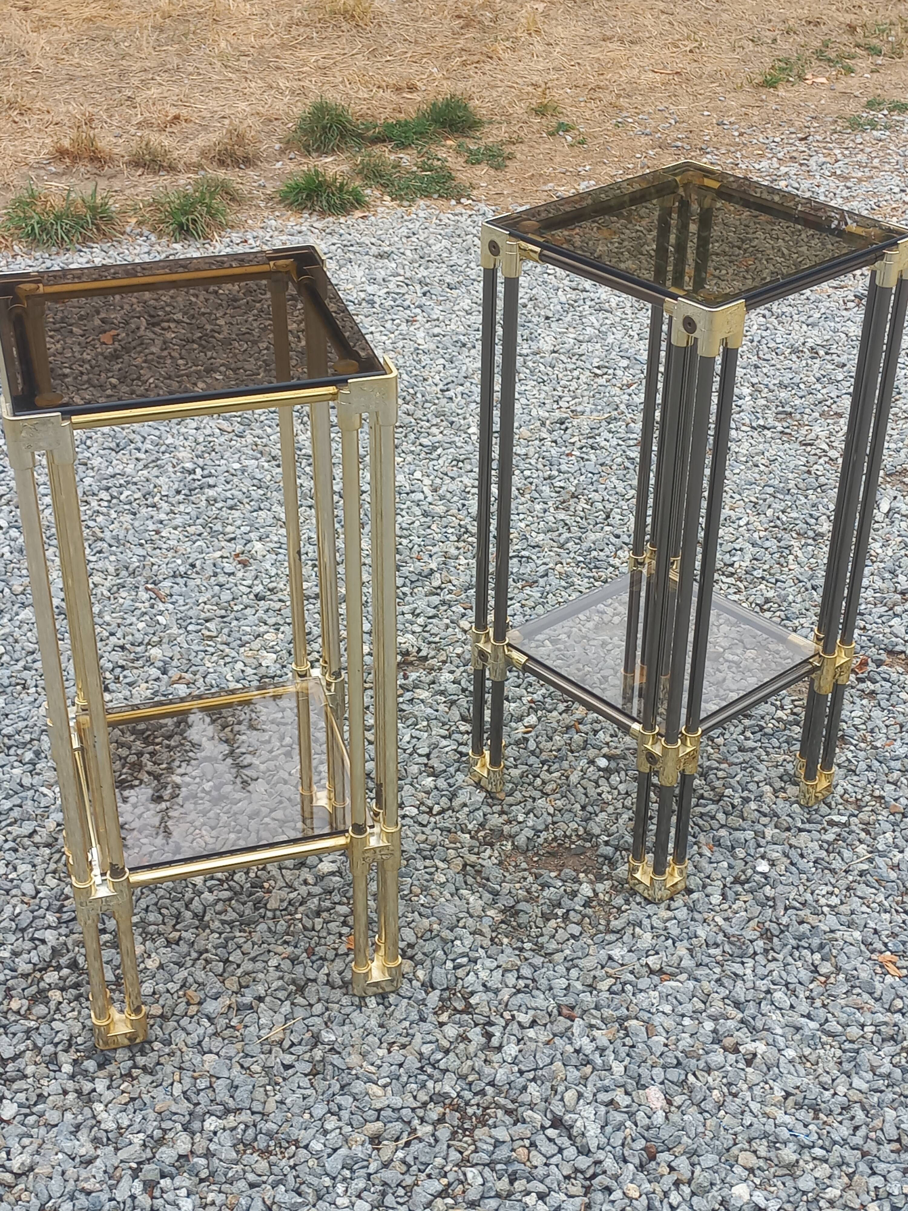 Pair of Hollywood Regency side tables in gold metal and smoked glass.