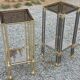 Pair of Hollywood Regency side tables in gold metal and smoked glass.