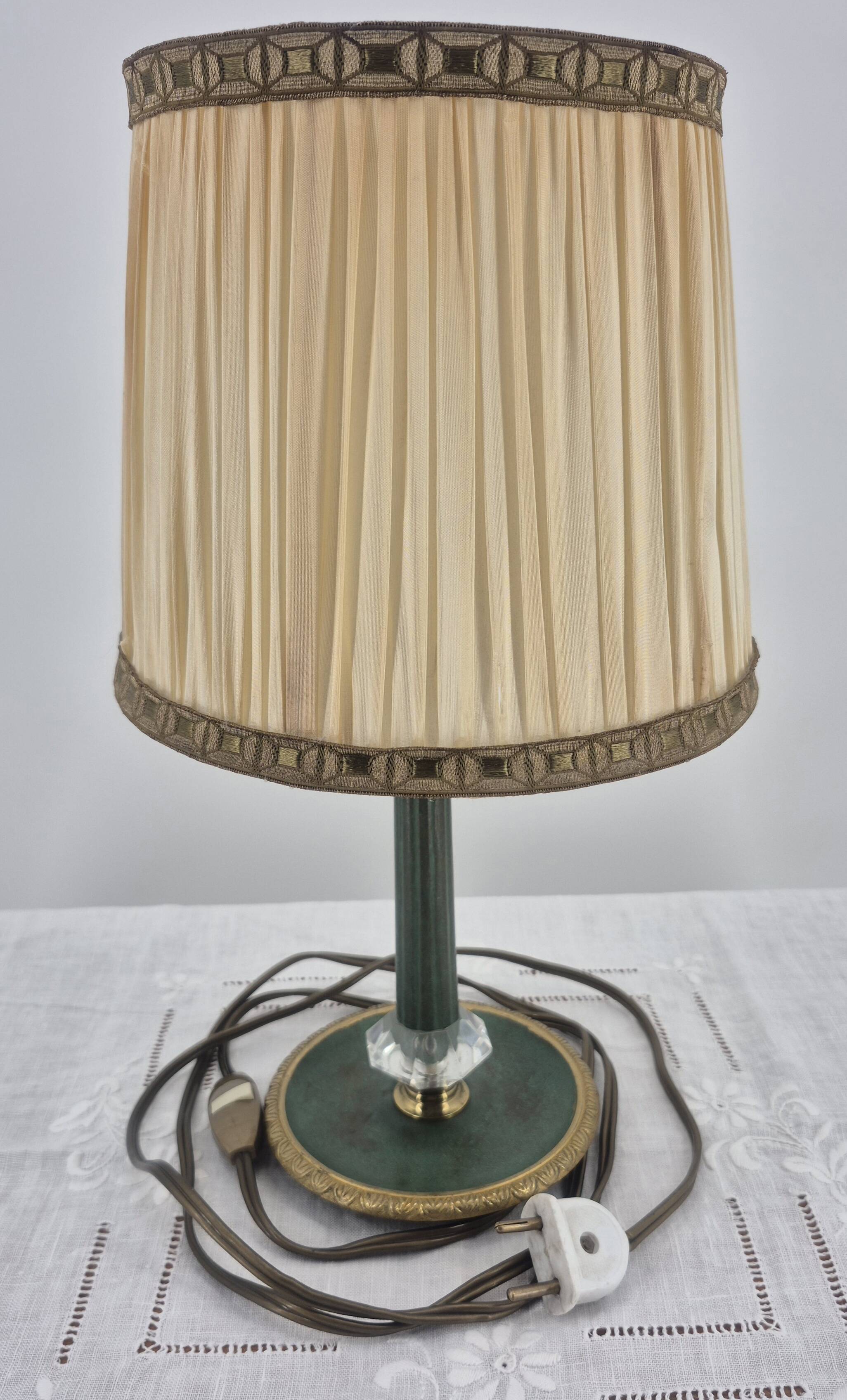 Brass table lamp with green patina and empire-style fabric shade.