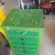 Vintage workshop furniture with 6 green drawers.
