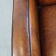 Art Deco design sheepskin leather armchair with a stunning patina