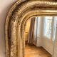 Very large Louis Philippe mirror with gold leaves.