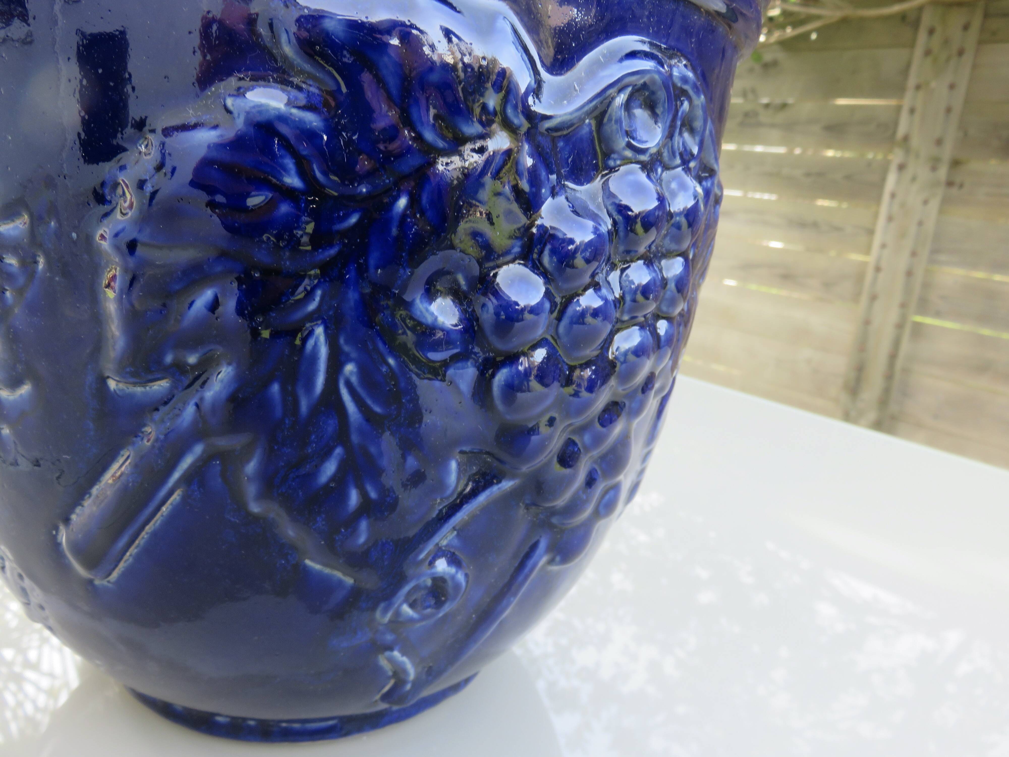 Wall pot in glazed blue terracotta with a grape motif, 1970s.