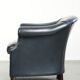 Dark blue club armchair made of cowhide leather with a timeless design