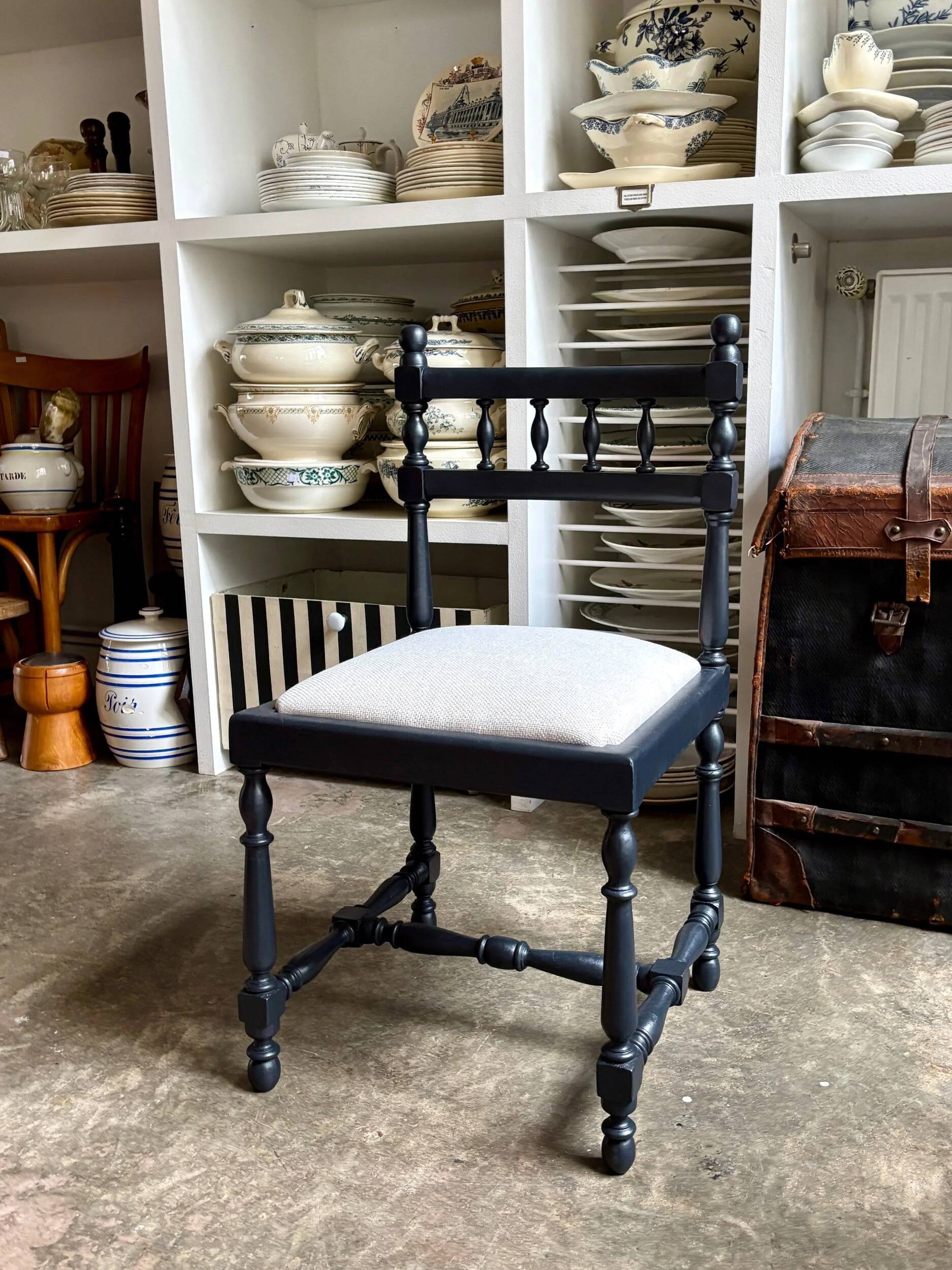 Black turned wooden chair and ivory cotton.