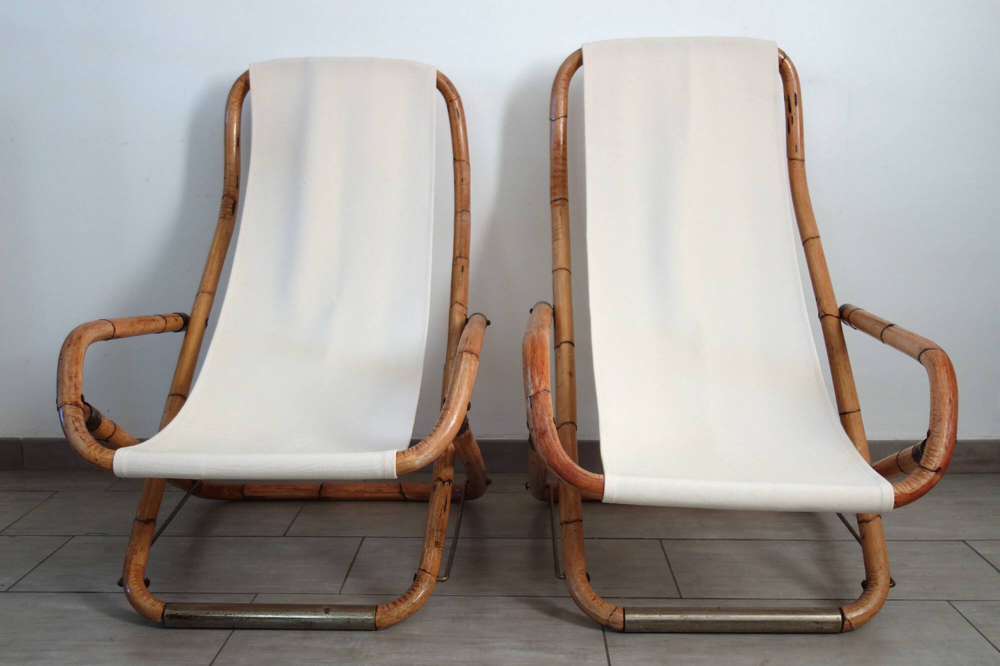 Pair of folding bamboo and brass deck chairs, Italy, 1960s.