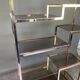 Italian shelf in gold-plated metal and smoked glass