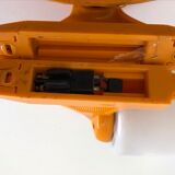 Tilting orange plastic mirror with its matching wall light