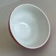 Red bowl with white polka dots signed Longchamp Porcelaine France