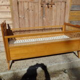 Vintage baby bed in rattan