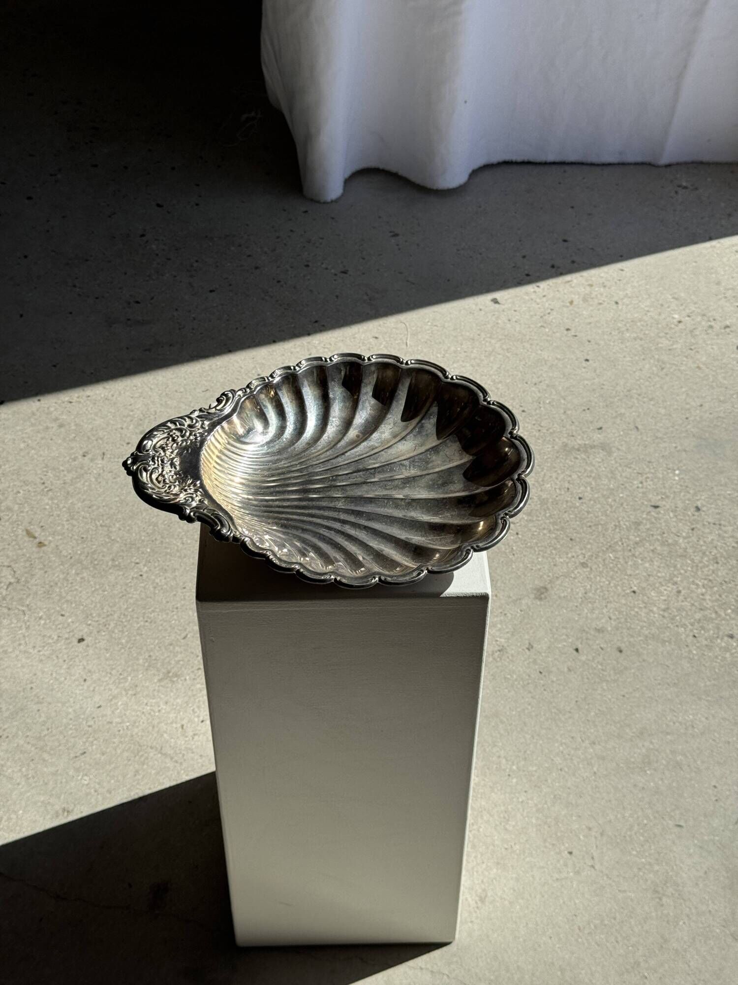Large antique silver-plated bowl in the shape of a shell.