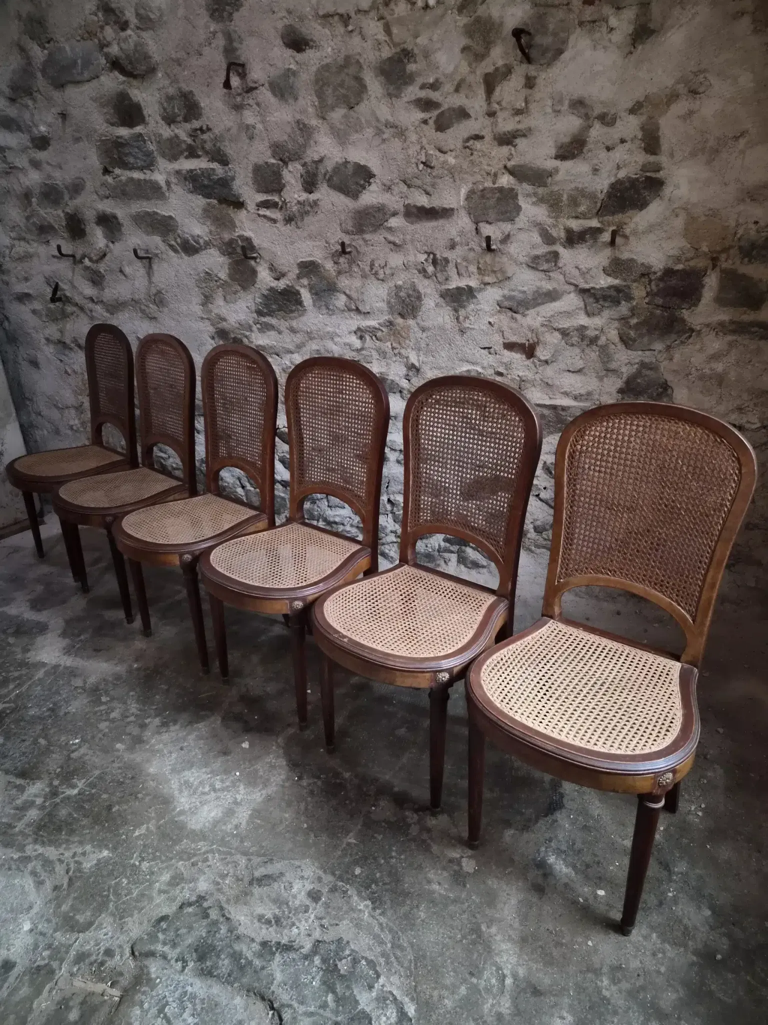 Set of 6 antique Louis XVI style dining chairs with caning.
