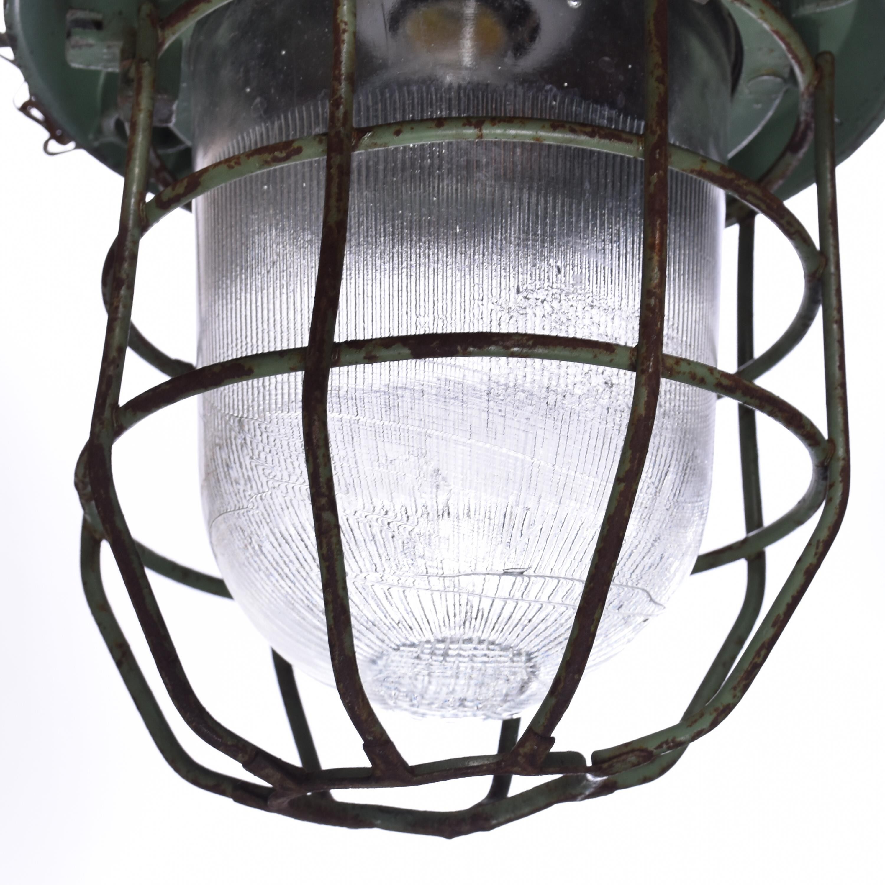 Industrial caged green lamp