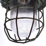 Industrial caged green lamp