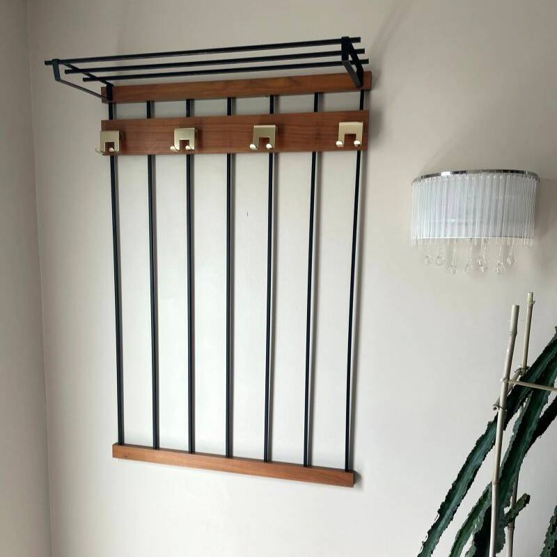 Wall-mounted coat rack in wood and black.