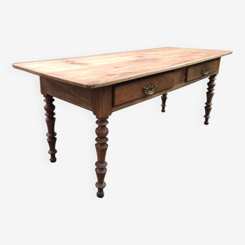 Antique Louis Philippe style farm table in solid cherry wood with 2 drawers and turned base.