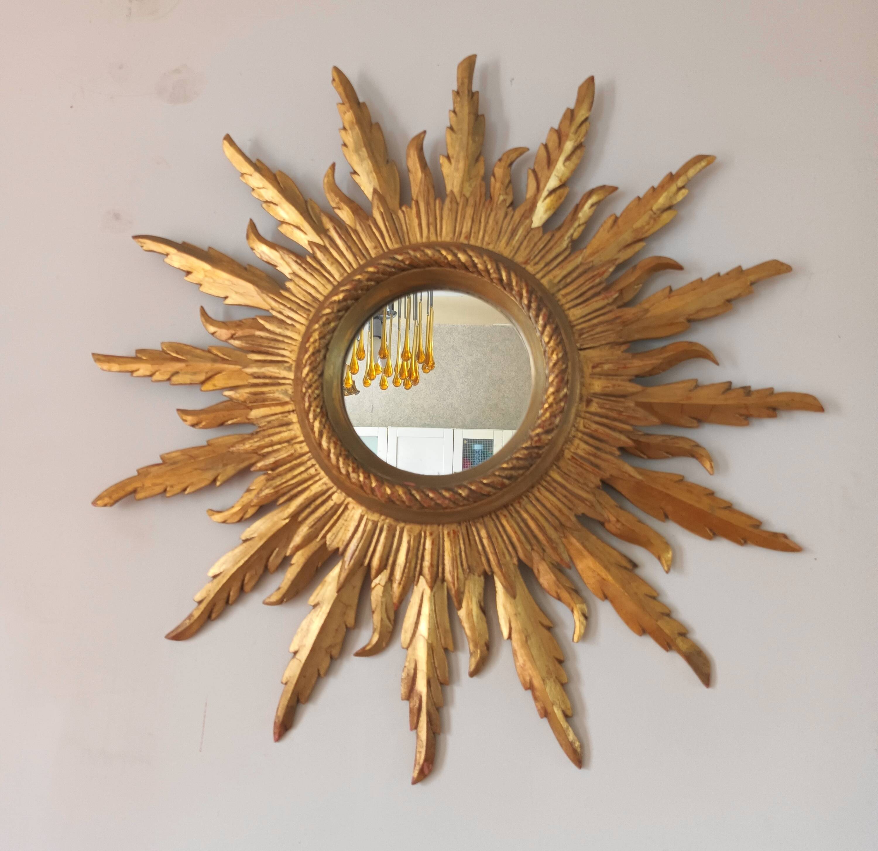 Sun mirror in carved gilded wood from the 1950s