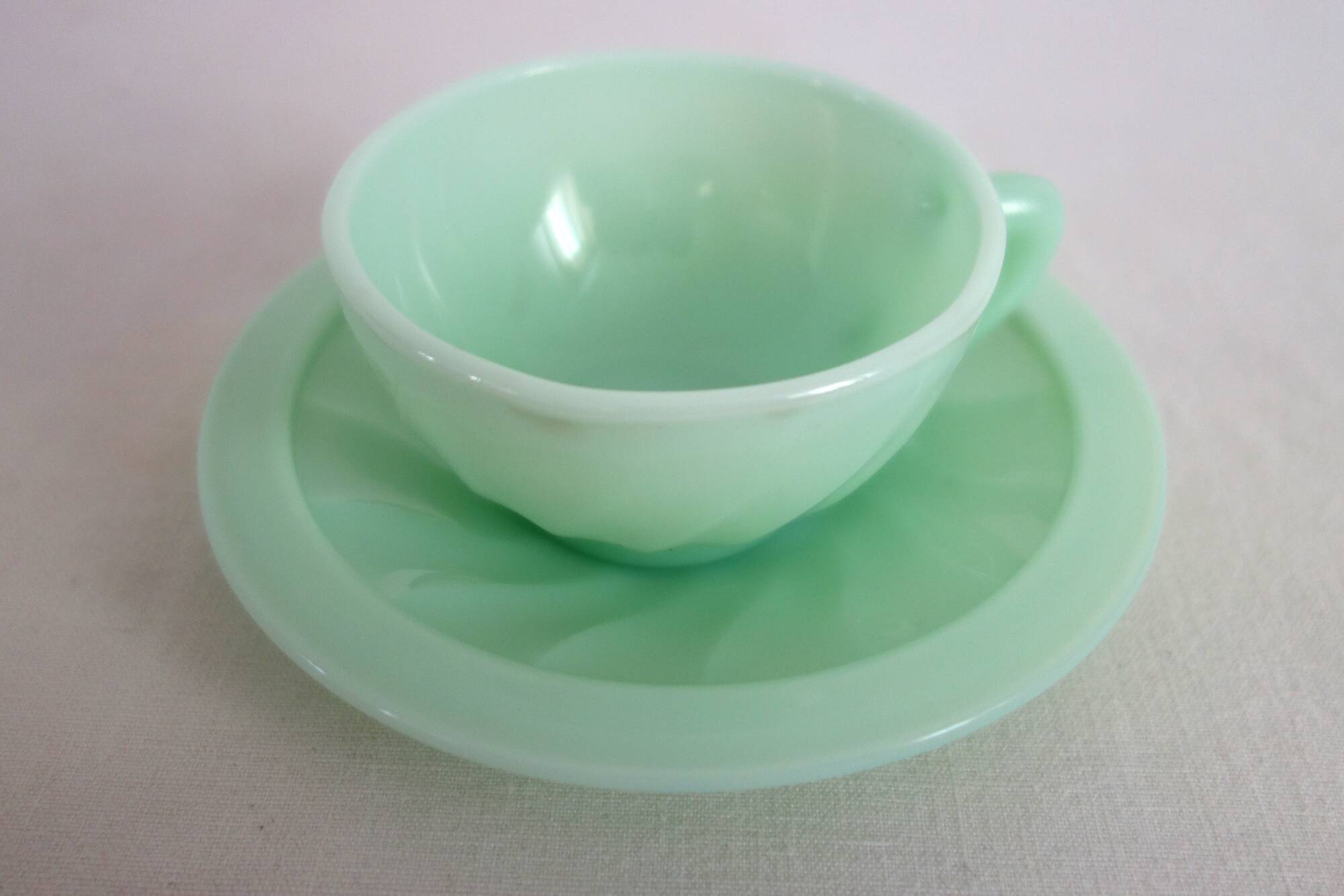10 almond green opaline cups and saucers from the 50s