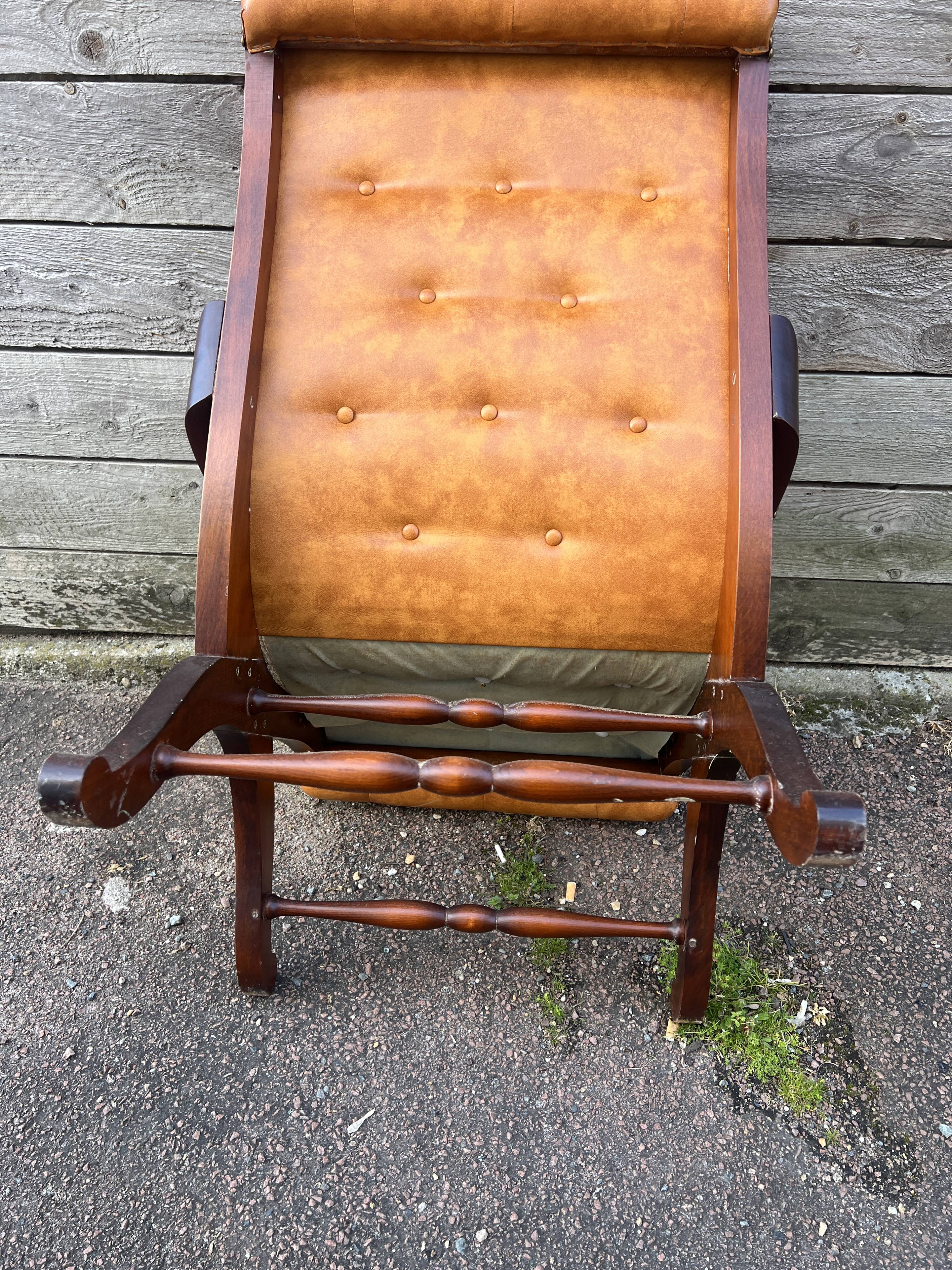 Chesterfield leather slipper chair with mahogany