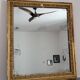 Golden stucco and wood Empire mirror