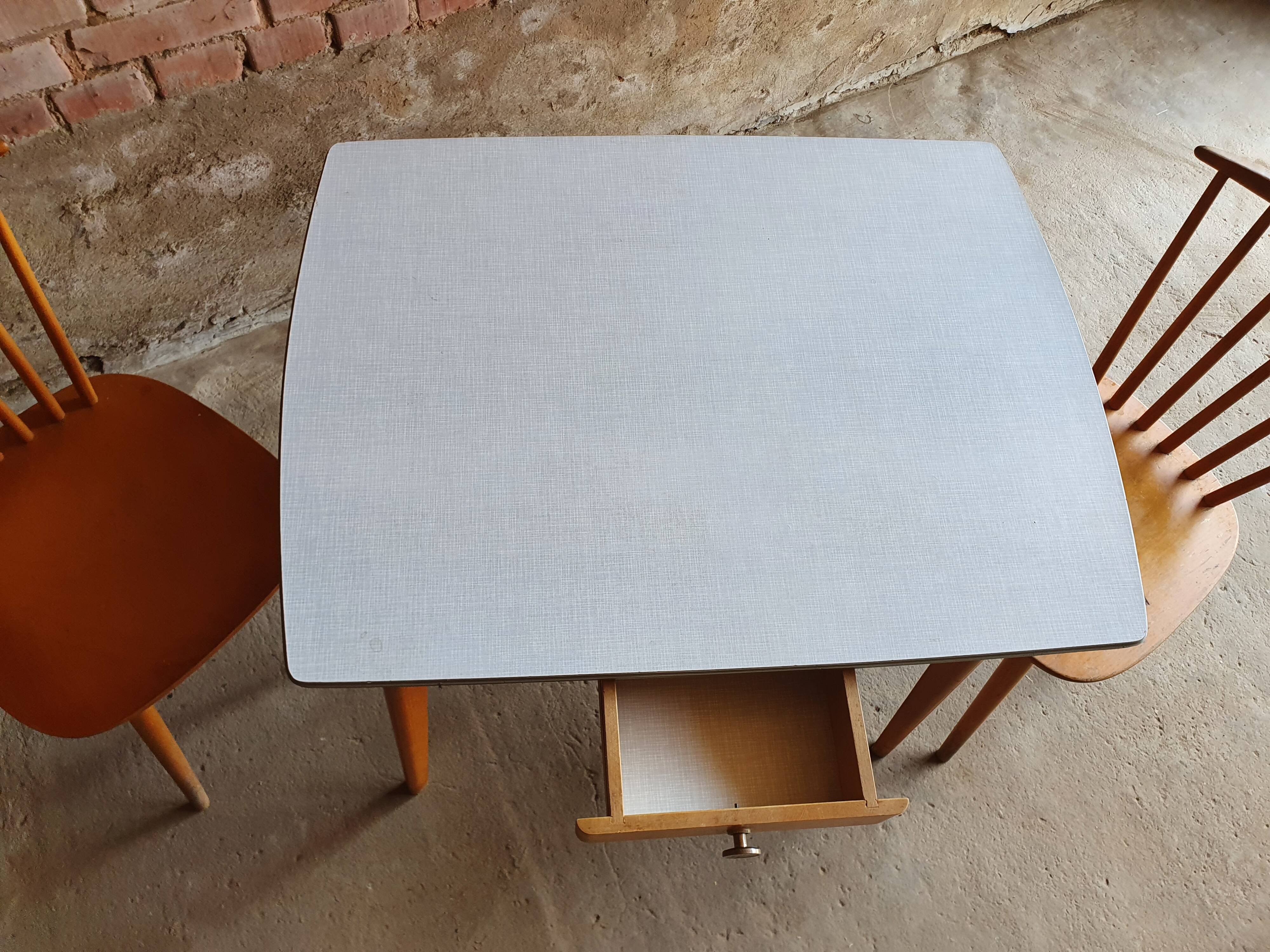 Together two Scandinavian chairs and its wooden and formica table