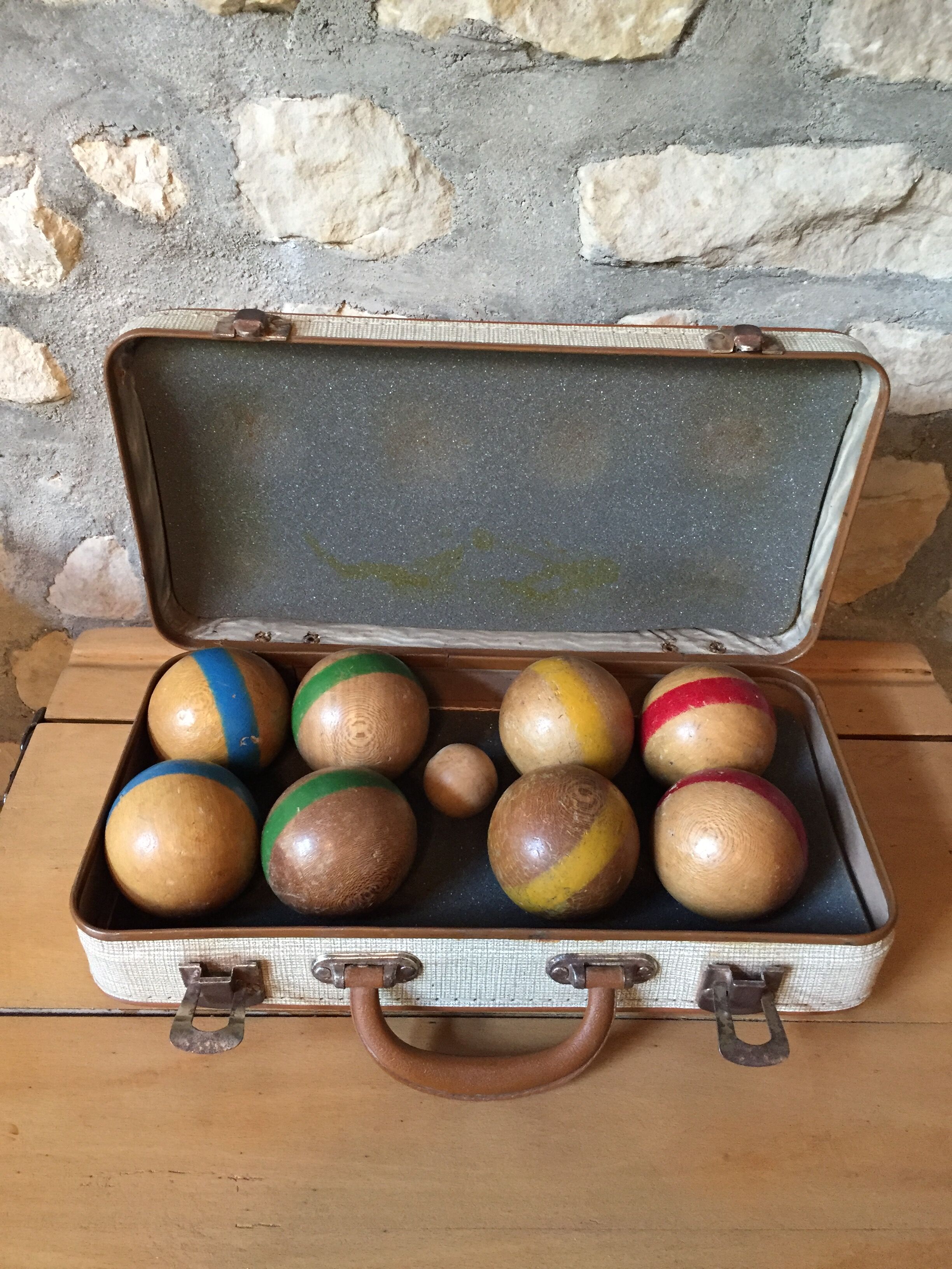 Old set of wooden balls in his suitcase