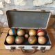 Old set of wooden balls in his suitcase