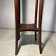 Vintage dark wood side table with curved base