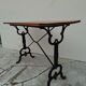 Solid oak bistro table with a cast iron base, signed.