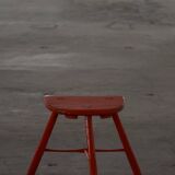 Pair of patinated wooden stools painted red with flared legs, 1950s-1960s.