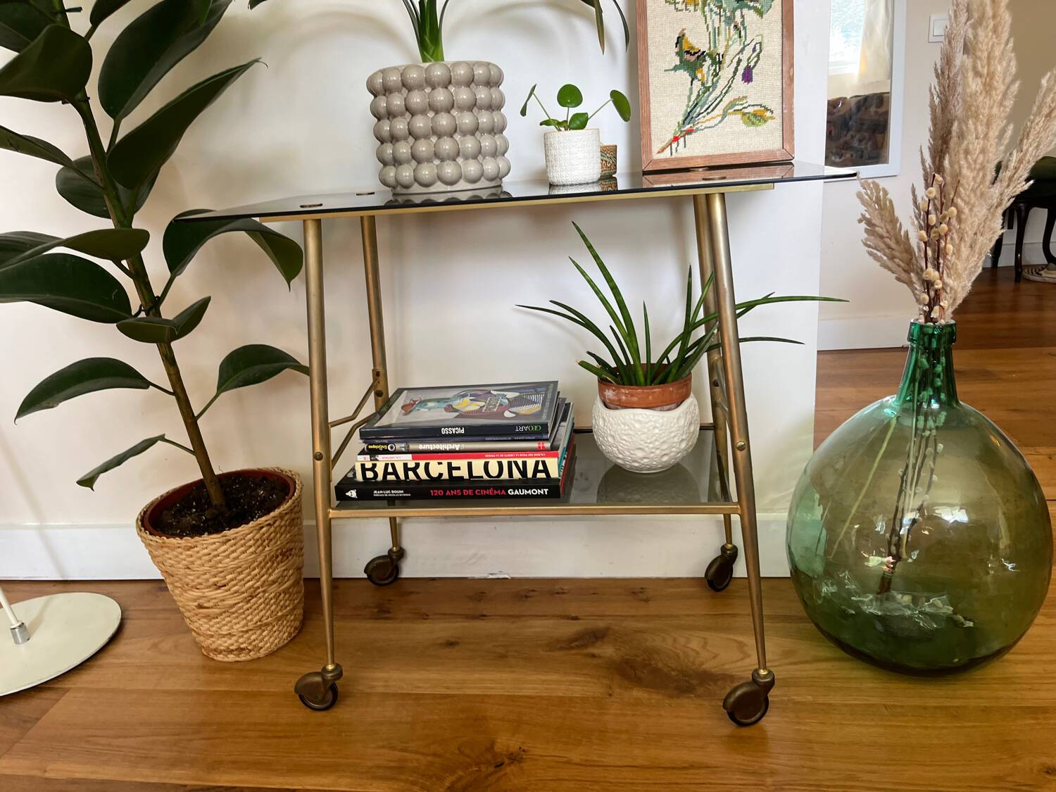 Vintage brass and smoked glass dessert trolley on wheels.