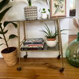 Vintage brass and smoked glass dessert trolley on wheels.