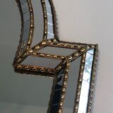 Mirror consisting of multi-faceted mirrors and brass garlands, French work, around 1970