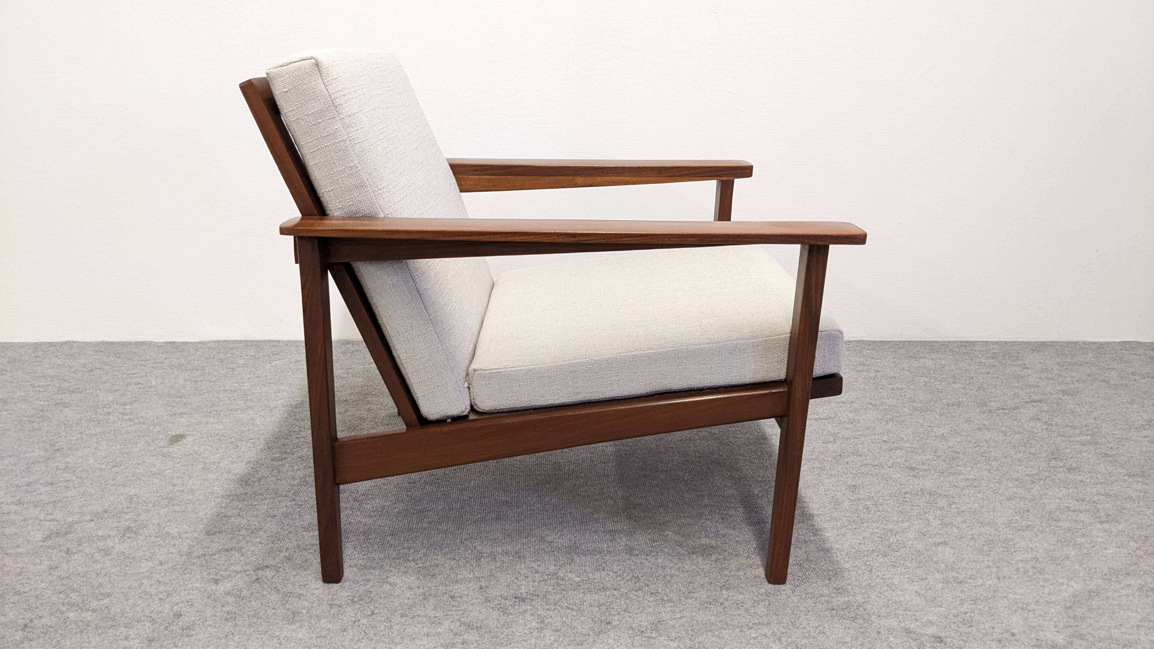 Living room, three-seater sofa and two armchairs, modernist in teak, France around 1950.