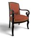 Restoration armchair in mahogany with cross arms and orange fabric.