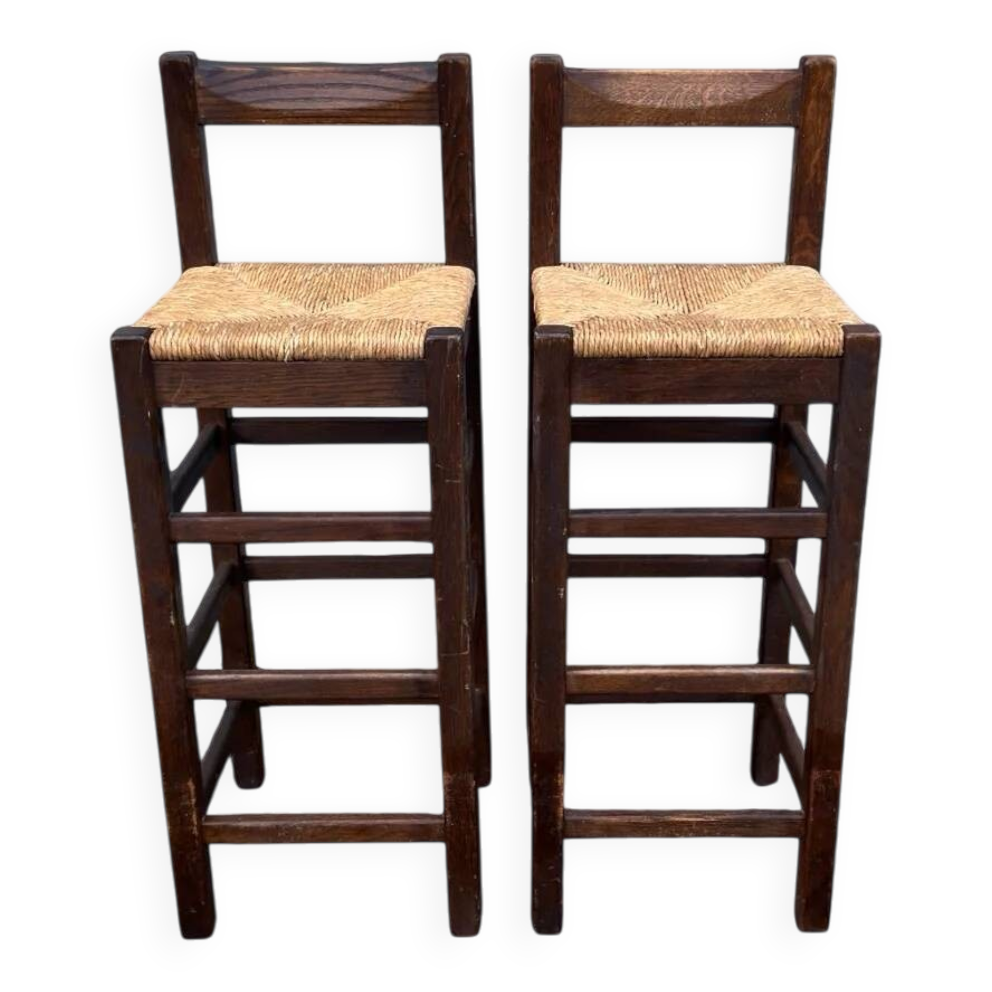 Set of 2 vintage wooden bar stools with woven straw seats.