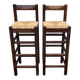 Set of 2 vintage wooden bar stools with woven straw seats.