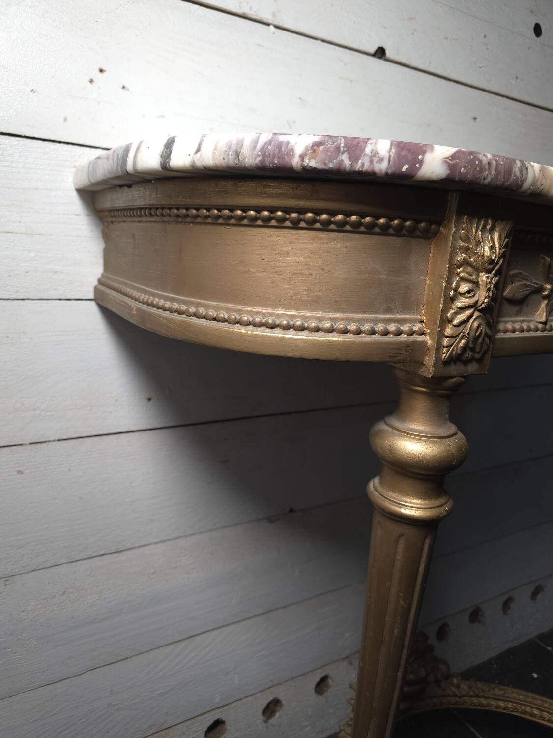 Louis XVI style console in gilded wood with a marble top.