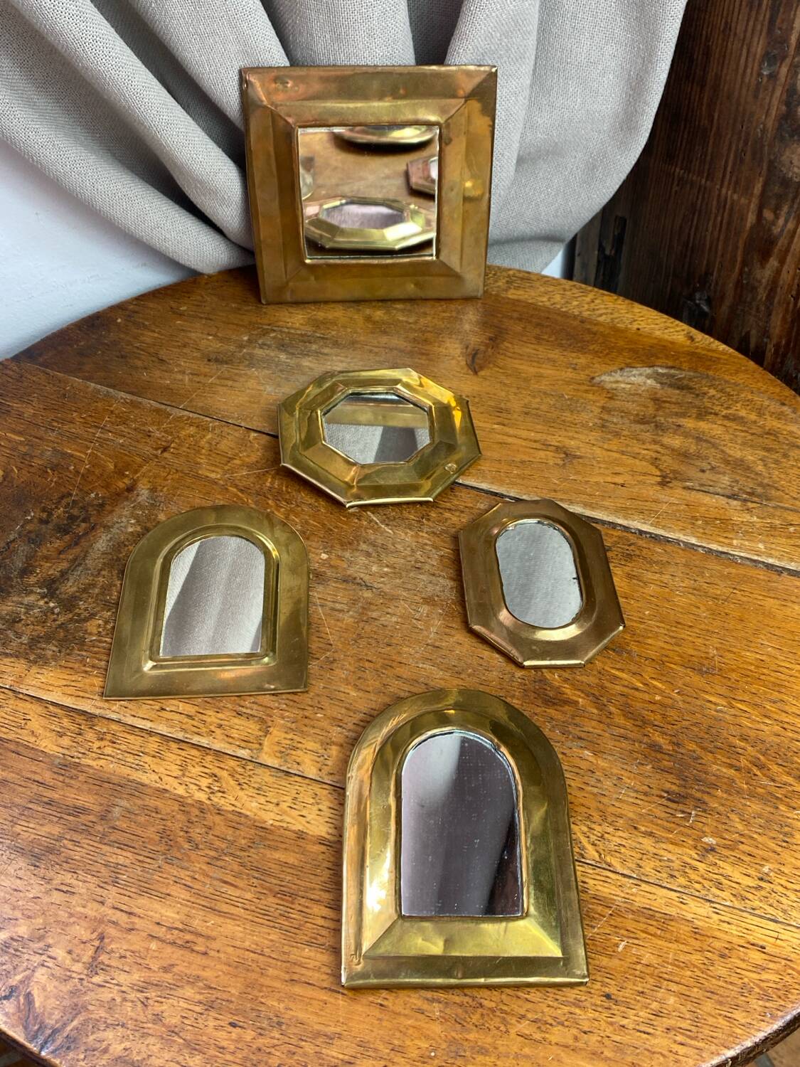 Set of five small wall mirrors in brass.